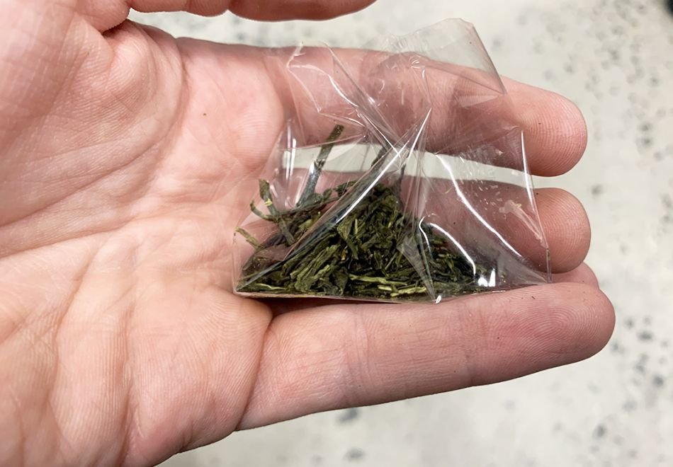 holding packaged weed in hand