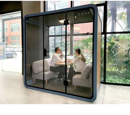 two people sitting inside a meeting room